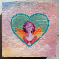 a painting of a girl in a heart shaped box
